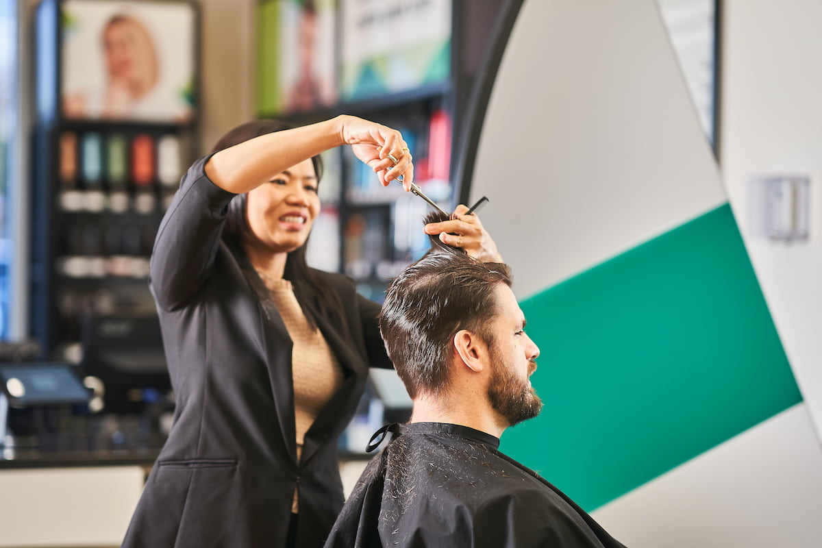 A customer at a Great Clips salon getting his hair styled