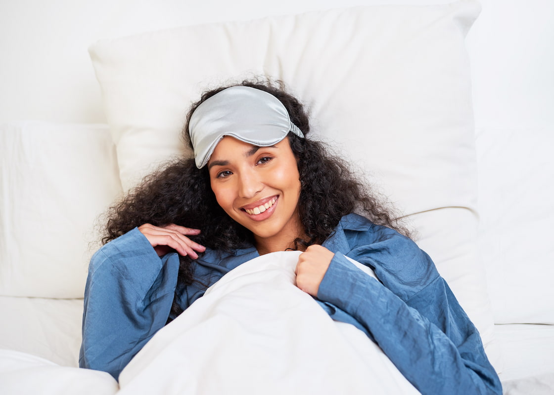 Woman with curly hair laying in bed